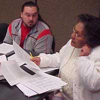 Nigel Lawrence and Darlene James peer review a research paper.
