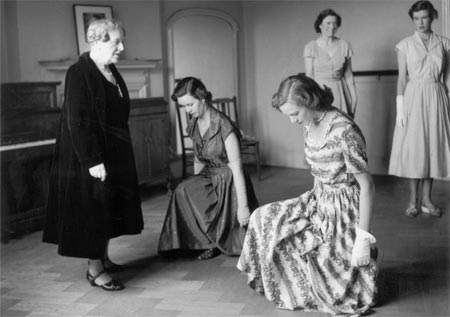 On bended knee: 1950s debutantes learn this essential element of social etiquette.