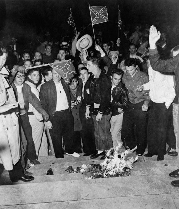 University of Alabama students react to Lucy's successful enrollment by burning desegregation propaganda